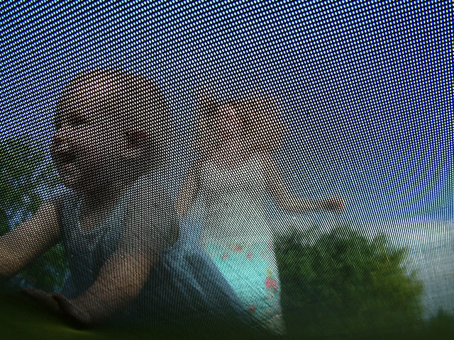 Your Pictures: Your Pictures: an image of a baby from the underneath of a trampoline