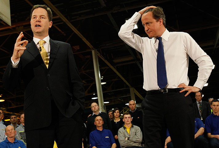 Picture desk live: David Cameron listens to Nick Clegg during a visit to CNH Tractors