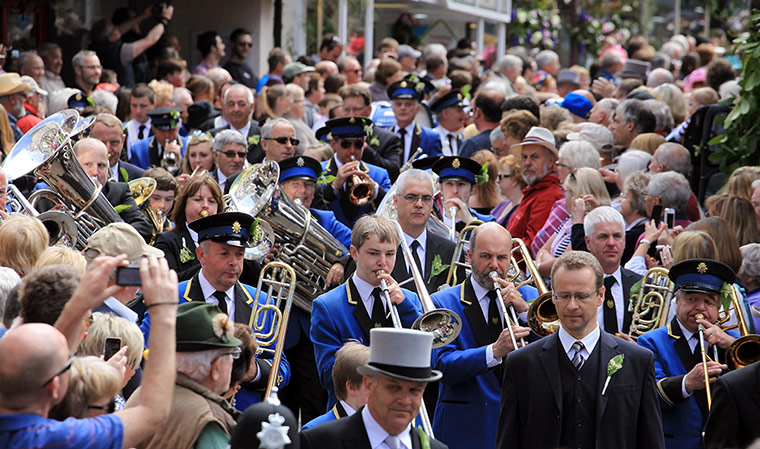 Helston Flora Day: Dancers make their way through the town