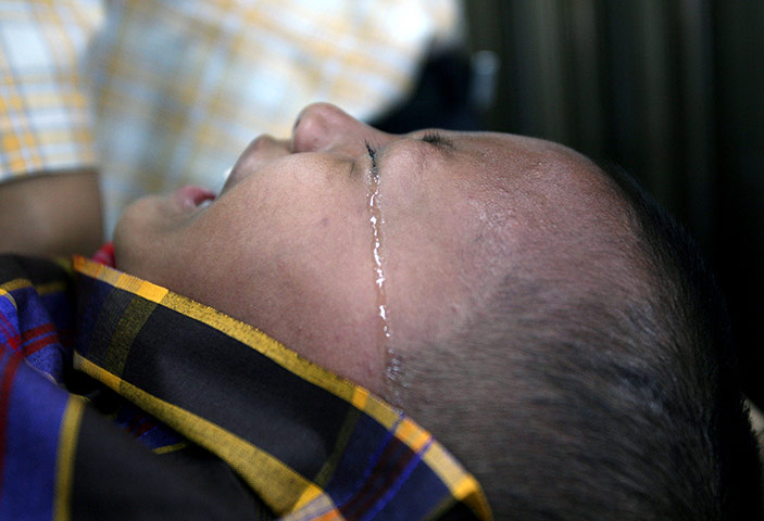 24 hours in pictures: A boy cries as he is being circumcised 
