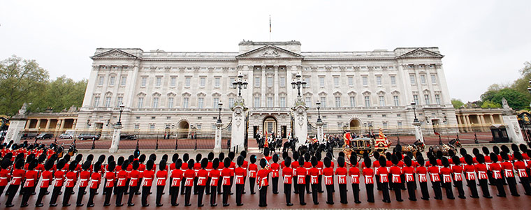 State Opening: Irish Guards stand to attention as Queen Elizabeth's carriage passes