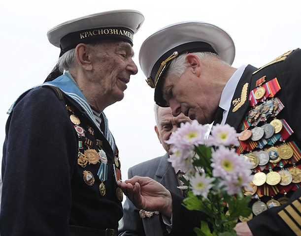 Victory Day in Russia: A Russian Navy WWII veteran examines the medals of navy sailor 