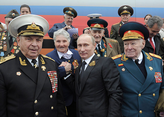 Picture desk live: President Putin poses with veterans after the Victory Parade in Red Square