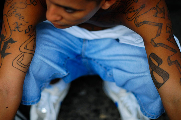 Longer View: A gang member and inmate sits inside the jail 