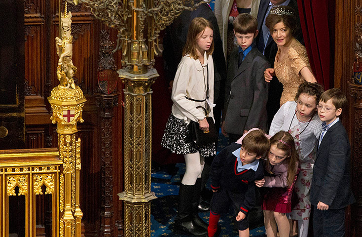 Picture desk live: Children peering around the corner to watch the scene at parliament 
