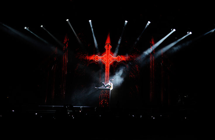 Madonna: Madonna on stage under a crusifix