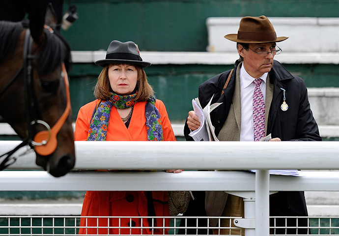 24 hours in pictures: Racegoers watch the runners in the parade ring at Sandown racecourse