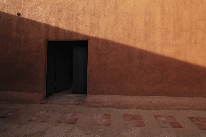 Pilgrimage: Door in adobe wall at Georgia O'Keeffe's home 