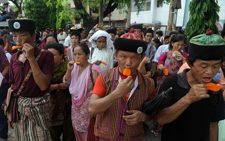 Picture desk live: Members of the Lepcha tribe eat ice-lollies at a rally in Siliguri