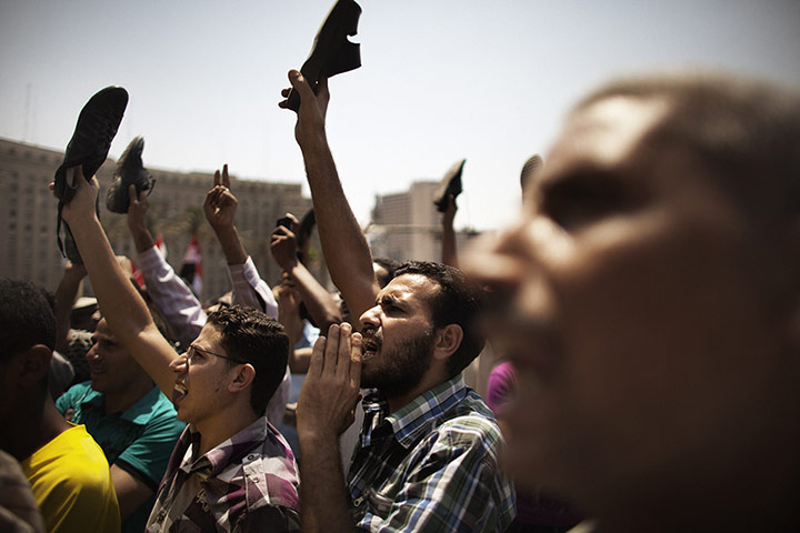 Picture desk live: Egyptians raise their shoes in political protest in Tahrir Square, Cairo