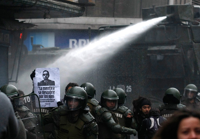 24 hours: Santiago, Chile: Riot police use a water cannon at anti-Pinochet demo