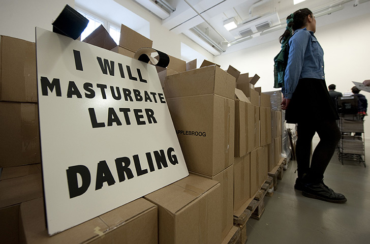 dOCUMENTA (13): A woman walks past a painting by US artist Ida Applebroog
