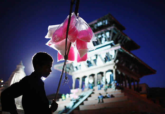 Picture Desk Live: A boy selling cotton candy waits for customers on the streets of Kathmandu