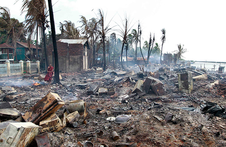 Burma violence: A Buddhist monk stands in the debris of burned houses in Sittwe