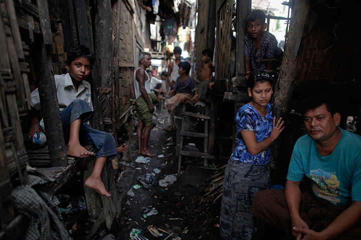 Burma violence: Burma Rohingya people pass the time at their slum near the sea in Sittwe