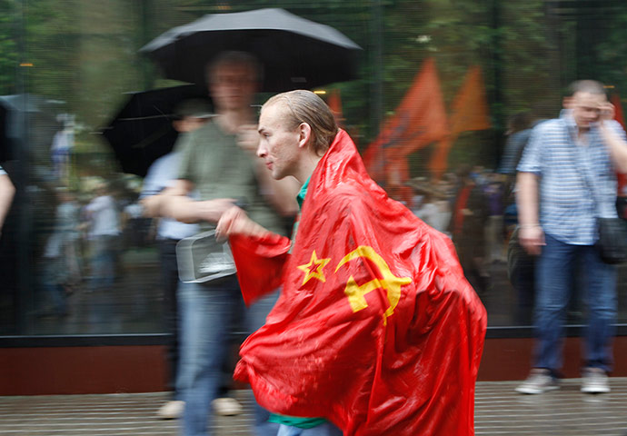 Picture desk live: An activist wearing a Soviet flag during a protest in Moscow