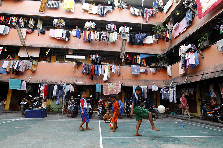 24 hours in pictures:  Indonesian boys playing soccer at a crowded flat