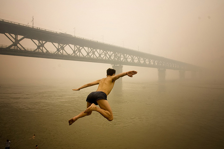 24 hours in pictures: Man jumps into a river in a heavy fog in Wuhan