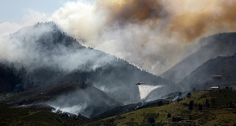 Colorado wildfires: Helicopter drops water on fire close to homes near Horsetooth Reservoir
