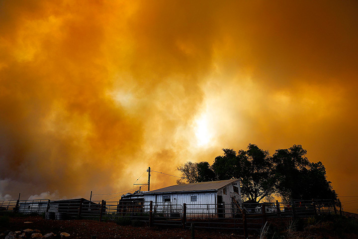 Colorado wildfires: Smoke fills the air over a small barn at High Park Fire burns near Laporte