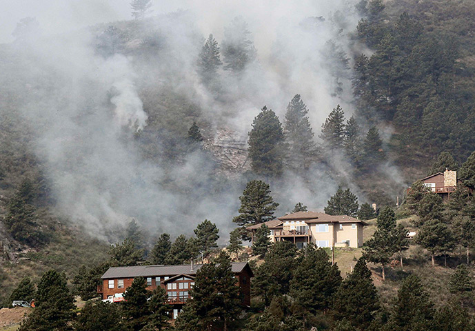 Colorado wildfires: The forest burns behind houses in Colorado's High Park Fire