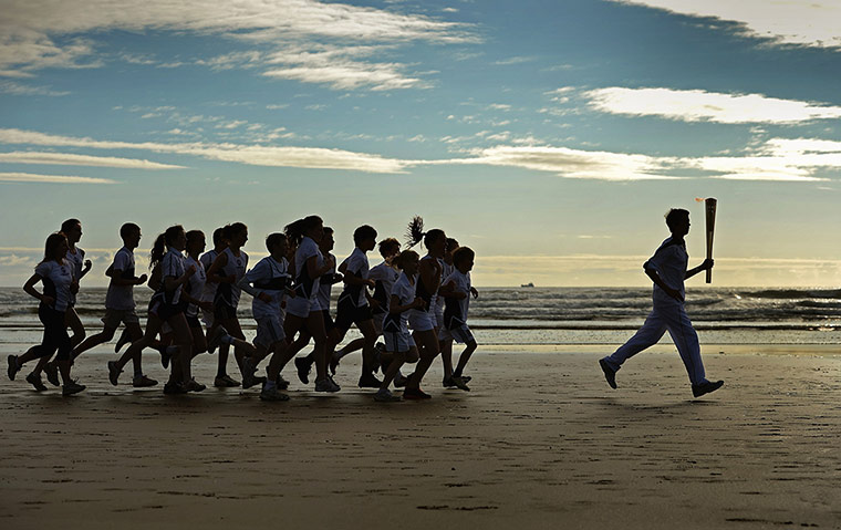 Picture desk live: The Olympic Torch Continues Its Journey Around The UK