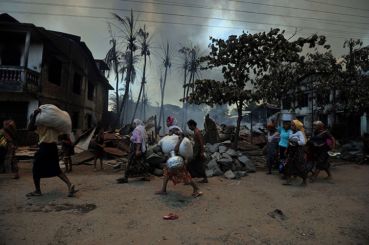 24 hours: Sittwe, Burma: Muslim residents carry their belongings as they evacuate