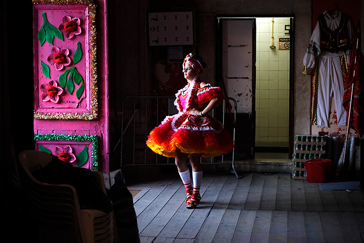 24 hours: Lisbon, Portgual: A young woman practices for Popular Saints festivities