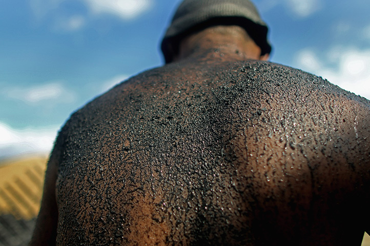 24 hours: Rondon Do Para, Brazil: Worker loads charcoal from illegally harvested wood