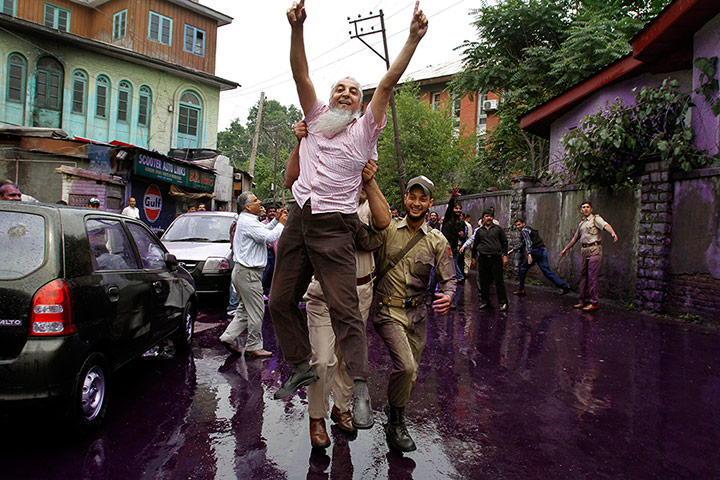 Picture desk live: A government employee is detained at a protest in Srinigar