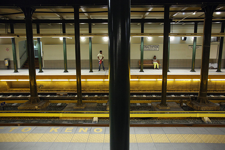 Greece: 13-14 June: Passengers wait for an underground train in the early morning in Athens