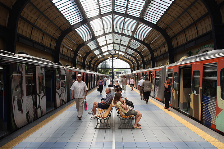 Greece: 13-14 June: Passengers wait on the platform of Piraeus station