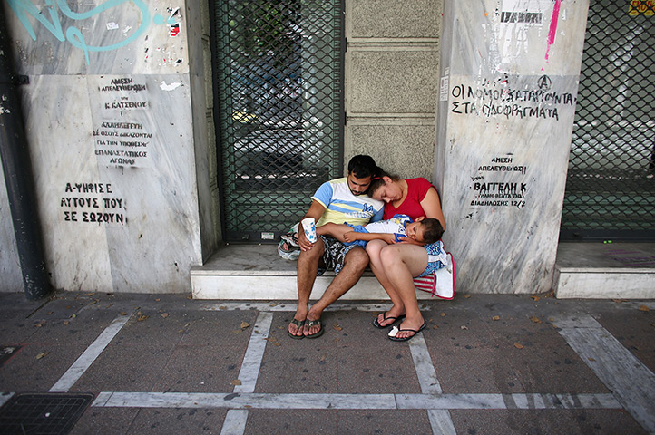24 hours in pictures:  family beg on the street in Athens, Greece