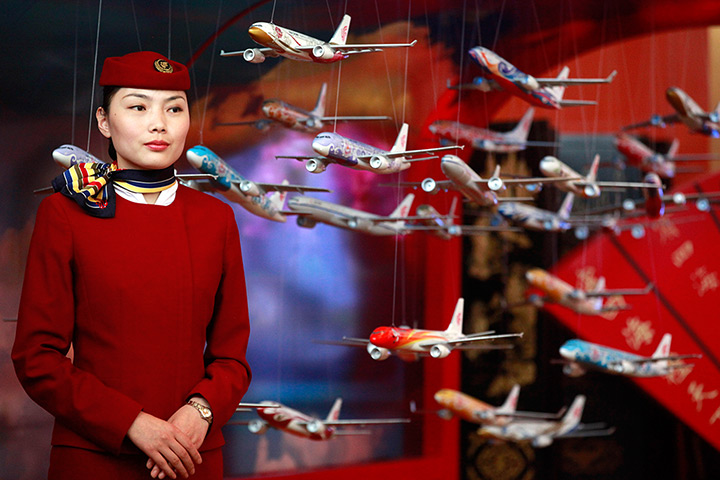 Week in Business: An Air China flight attendant stands at the IATA AGM