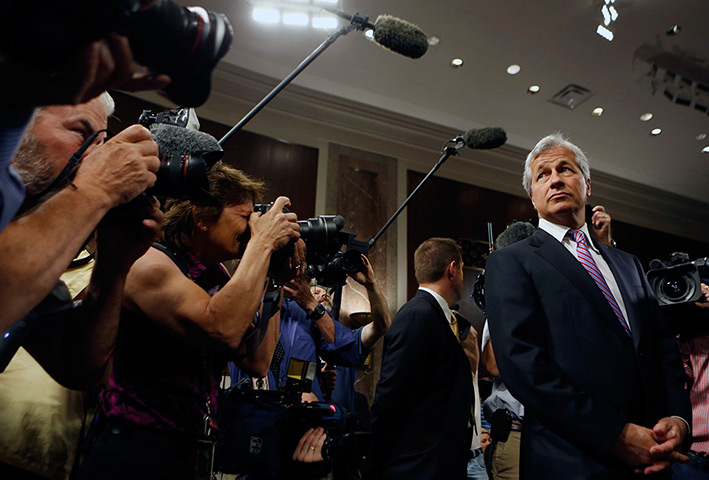 Week in Business: Jamie Dimon is surrounded by the media as he arrives to testify