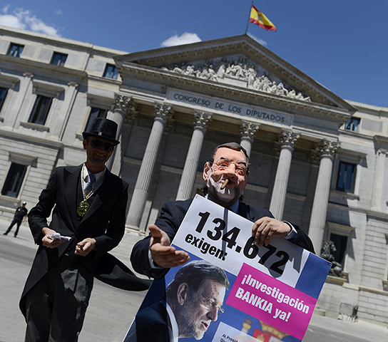 Week in Business: Activists stage a satirical performance in Madrid