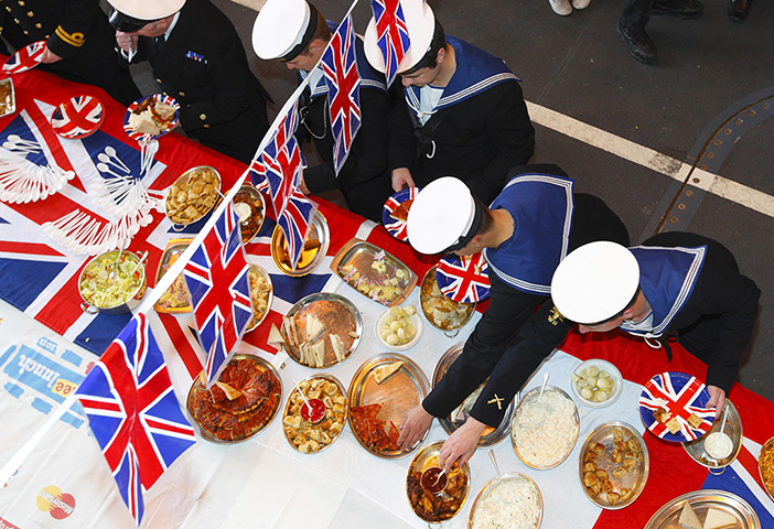 Week in Business: Sailors help themselves to food during a Daimond jubilee street party 