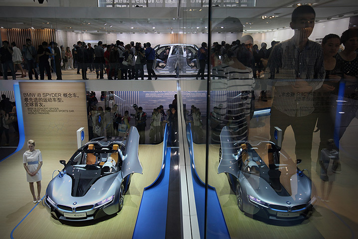 Week in Business: A model stands beside a BMW i8 Spyder concept car 