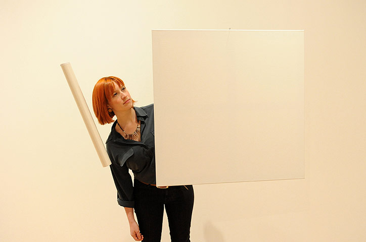 Invisible Art: A spectator looks at a white sheet of paper that appears suspended in air