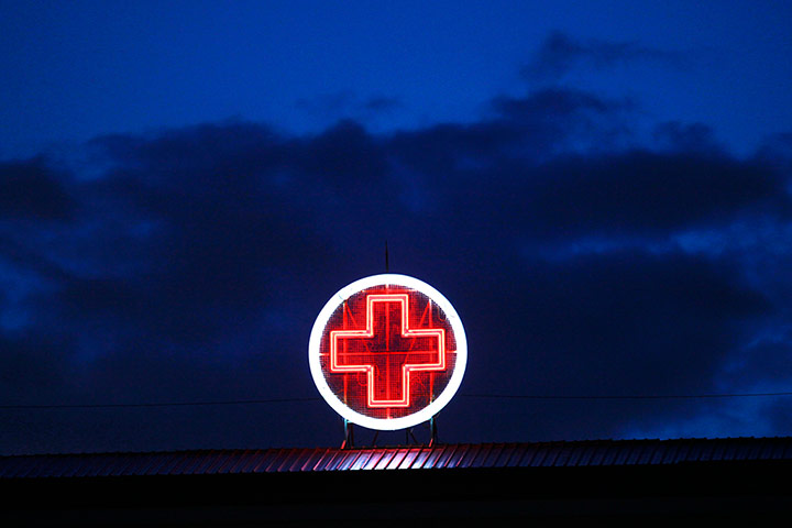 Greece: health system: A red neon cross on the Evangelismos Hospital 