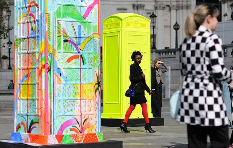 Picture desk live update: People walk amid decorated telephone boxes 