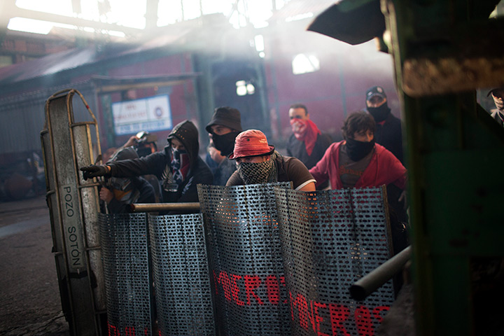 24 hours in pictures: Coal miners protest behind shields, Spain