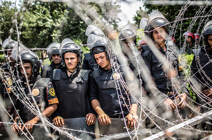 24 hours in pictures: gyptian military police form a barricade during a protest