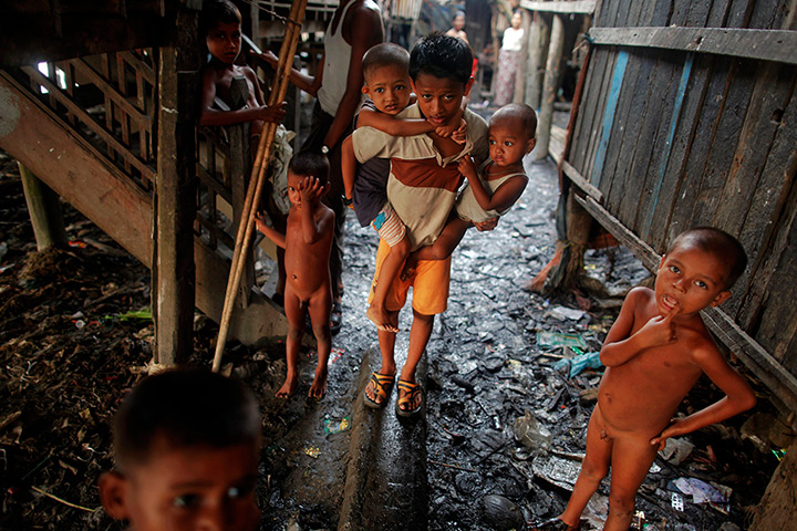 24 hours in pictures: Rohingya children walk though the slum, Burma