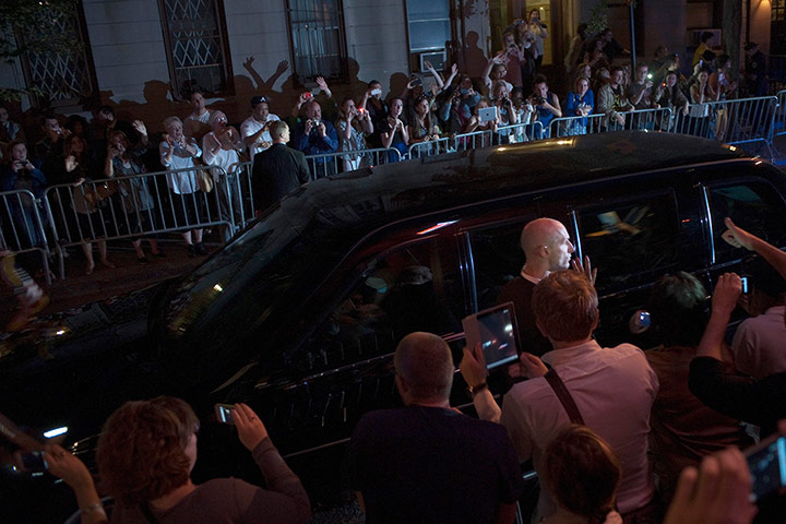 Obama fundriser NYC: Pedestrians watch Obama's motorcade 