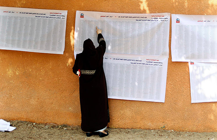 Egypt elections: A voter checks her name at a polling station