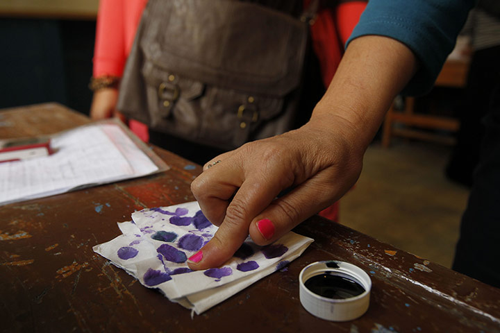 Egypt elections: An Egyptian woman dips her finger in ink