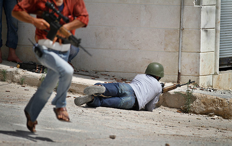24 Hours: A Free Syrian Army fighter fires his weapon at Syrian troops