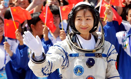 Liu Yang, China's first female astronaut, waves during a launch ceremony