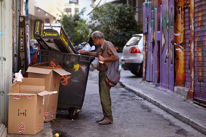 Andy Hall Athens: A man looks through dustbins in Athens